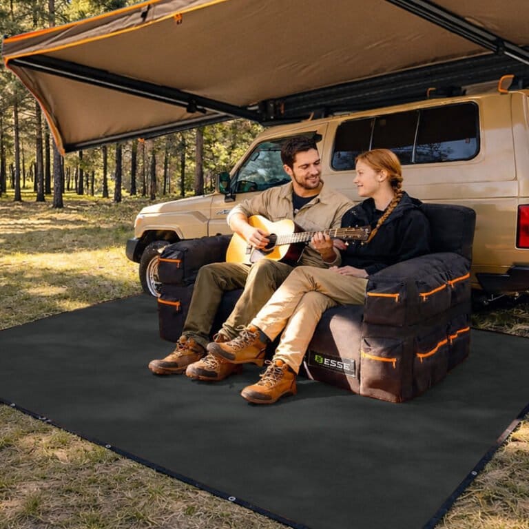 Couple relaxing on the Air Sofa under a vehicle awning