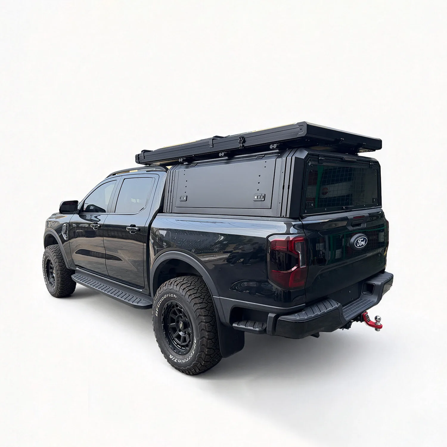 Light clamshell roof top tent closed on a Ford Ranger with canopy