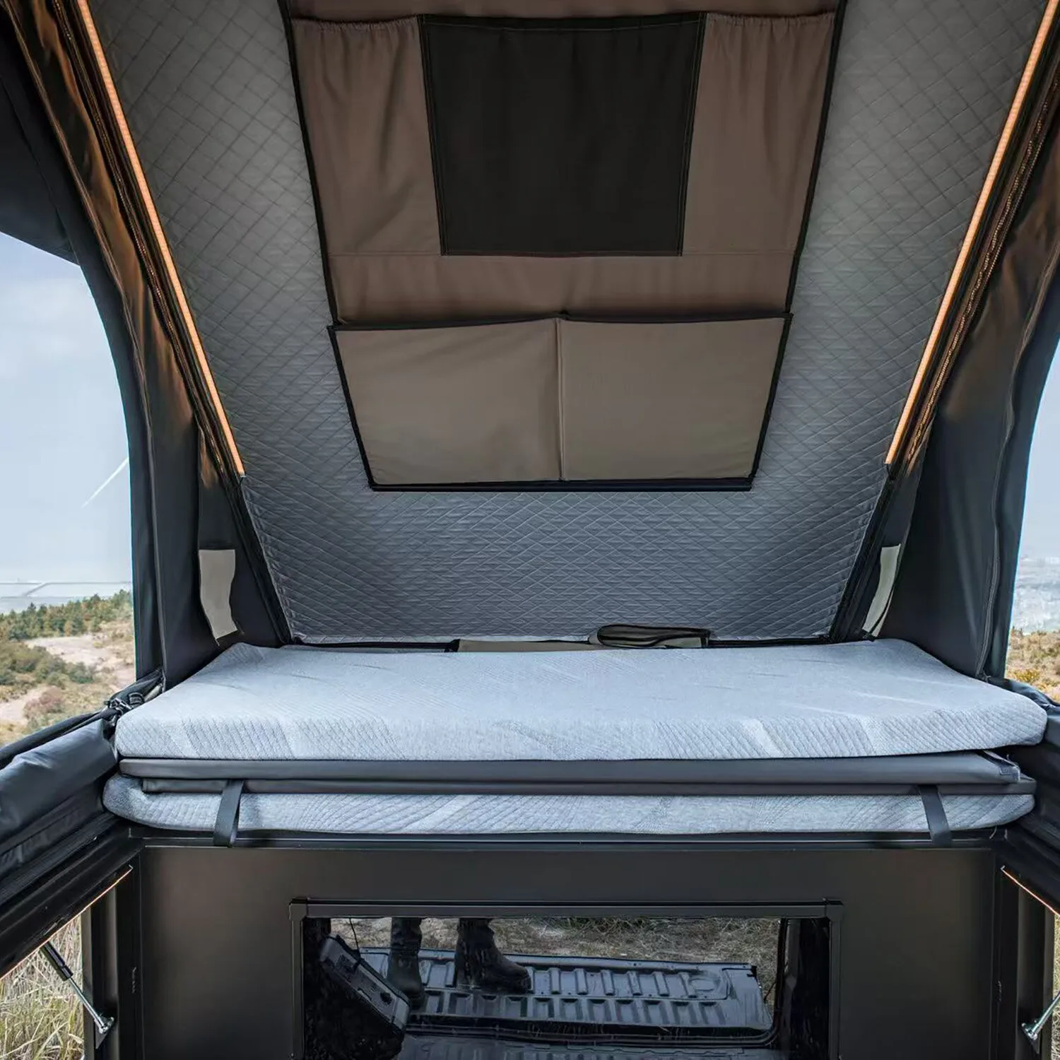 Inside the Pick-Up Canopy Clam Shell tent, mattress and access from the bed box